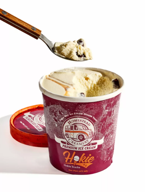 A spoonful of Hokie Tracks ice cream being scooped from a pint container