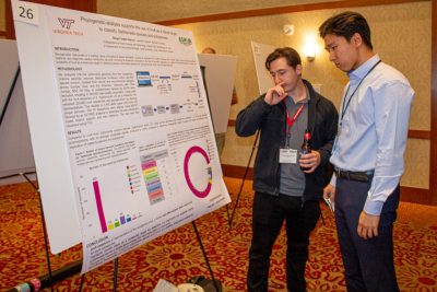 Diego Fredes-Garcia discusses his poster with a passerby