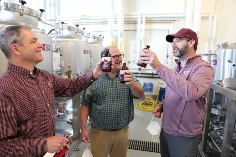 Three brewing professors hold Fightin' Hokies Lager