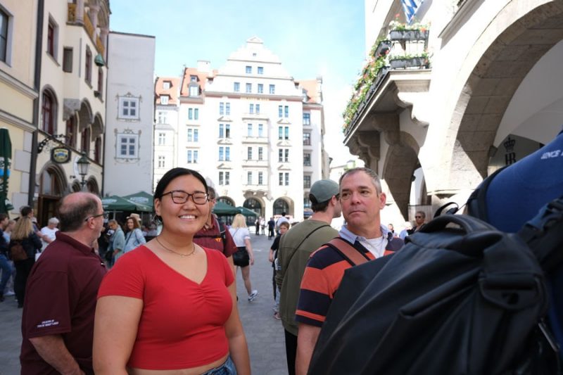 Nancy walking german city streets with people around her