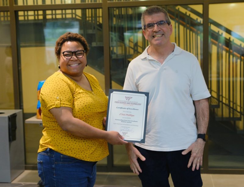 Dr. Joe Eifert presents FST graduate student J'Nai Phillips the with the Outstanding First Year Graduate Student Award.