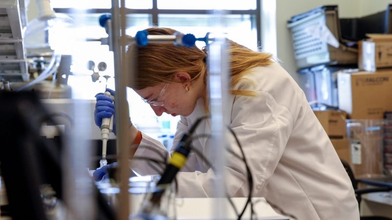 Student working with a pipette in a lab
