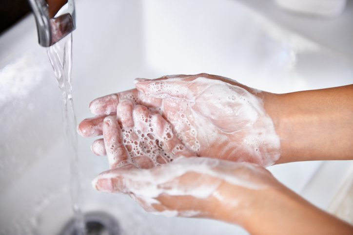 image of person washing hands 